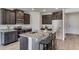 Modern kitchen features stainless steel appliances, dark cabinetry, and a granite countertop island with bar stool seating at 4188 Sw 53Rd Lane Rd, Ocala, FL 34474