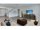 Spacious living room with neutral tones, wood-look floors, comfortable seating, and a view of the staircase at 4188 Sw 53Rd Lane Rd, Ocala, FL 34474