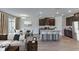 Open concept features living, dining and kitchen with bar seating, stainless appliances, and wood-look floors at 4188 Sw 53Rd Lane Rd, Ocala, FL 34474