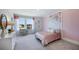Bright bedroom with pink accent wall, a desk, and scenic views at 4196 Sw 53Rd Lane Rd, Ocala, FL 34474