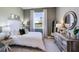 Cozy bedroom with lake views, neutral walls, and a rustic dresser at 4196 Sw 53Rd Lane Rd, Ocala, FL 34474