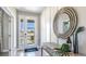 Bright entryway featuring a large decorative mirror, a stylish console table, and a view of the outdoors through the glass front door at 4196 Sw 53Rd Lane Rd, Ocala, FL 34474