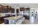 Modern kitchen featuring a granite island with seating, stainless steel appliances, dark cabinets, and an open layout at 4196 Sw 53Rd Lane Rd, Ocala, FL 34474