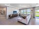 Bright living room with a comfortable white sectional, stylish decor, a large TV, and scenic views through expansive windows at 4196 Sw 53Rd Lane Rd, Ocala, FL 34474