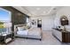 Bright bedroom features a decorative accent wall, tray ceiling, and a view of the lake at 4196 Sw 53Rd Lane Rd, Ocala, FL 34474