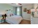 Cozy bedroom with a full bed and pastel green walls, plus decorative plants and artwork at 4251 Sw 53Rd Lane Rd, Ocala, FL 34474