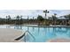 Inviting community pool has cabanas, lounge chairs, and palm trees, creating a relaxing resort-style ambiance at 4251 Sw 53Rd Lane Rd, Ocala, FL 34474