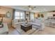 Cozy living room with white sofas, neutral decor, and tile floors flowing into the kitchen and dining area at 4251 Sw 53Rd Lane Rd, Ocala, FL 34474