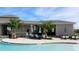 Stylish poolside patio features dining tables, seating areas, and umbrellas for a comfortable outdoor experience at 4251 Sw 53Rd Lane Rd, Ocala, FL 34474