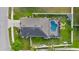 Aerial view of a home with a screened-in pool, fenced yard, and well-maintained landscaping at 4398 Ne 29Th St, Ocala, FL 34470