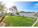 Large backyard with green lawn, white fence, and mature trees at 4398 Ne 29Th St, Ocala, FL 34470