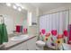 Bright bathroom featuring a white vanity, cabinet, and a shower with a floral curtain at 4398 Ne 29Th St, Ocala, FL 34470