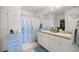 Bathroom featuring double sinks and a shower with a blue and white patterned curtain at 4398 Ne 29Th St, Ocala, FL 34470