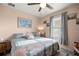 Calm bedroom features neutral walls, floral bedding, and soft window lighting creating a serene atmosphere at 4398 Ne 29Th St, Ocala, FL 34470