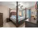Bedroom featuring a canopy bed, complemented by natural light and traditional decor at 4398 Ne 29Th St, Ocala, FL 34470