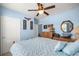 A cozy bedroom features blue walls, a ceiling fan, and a quilt-covered bed at 4398 Ne 29Th St, Ocala, FL 34470