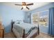 Cozy bedroom with blue walls, large window, and classic furniture at 4398 Ne 29Th St, Ocala, FL 34470