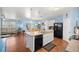 Open kitchen with stainless steel appliances, white cabinets, and an eat-in dining area at 4398 Ne 29Th St, Ocala, FL 34470