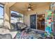 Covered patio with comfortable seating, ceiling fan, and outdoor decor at 4398 Ne 29Th St, Ocala, FL 34470