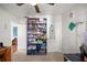 Storage area featuring a well-organized purple shelving unit with various items, next to a door at 4398 Ne 29Th St, Ocala, FL 34470