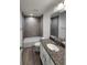 Well-lit bathroom with granite counters, single vanity and tiled shower-tub combo at 441 Nw Buena Vista Rd, Dunnellon, FL 34431