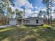 Charming single-story home featuring an attached garage and a well-manicured lawn at 441 Nw Buena Vista Rd, Dunnellon, FL 34431