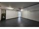 Spacious garage with sealed flooring, overhead lighting, and ample storage space at 441 Nw Buena Vista Rd, Dunnellon, FL 34431