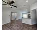 Open-concept living room with modern lighting, neutral paint, and wood-look floors at 441 Nw Buena Vista Rd, Dunnellon, FL 34431
