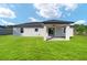 Spacious backyard with covered patio, lush lawn, and well-maintained exterior at 5 Willow Trl, Ocala, FL 34472