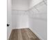 Walk-in closet with wood-look tile floor and wire shelving at 5 Willow Trl, Ocala, FL 34472
