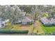An aerial shot of the home shows the roof, screened in porch, and tree lined street at 6127 Sw 84Th Place Rd, Ocala, FL 34476