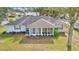 The backyard shows a grill, screened-in porch, lush lawn, and mature trees at 6127 Sw 84Th Place Rd, Ocala, FL 34476
