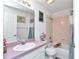 Clean bathroom with a pink vanity, shower/tub combo, and ample lighting at 6127 Sw 84Th Place Rd, Ocala, FL 34476