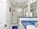 Clean bathroom with a glass-enclosed shower, blue countertop, and practical fixtures, providing a functional space at 6127 Sw 84Th Place Rd, Ocala, FL 34476