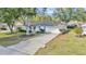 Charming home with well-manicured front yard and mature trees lining the driveway at 6127 Sw 84Th Place Rd, Ocala, FL 34476