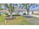 Charming home with well-manicured front yard and mature trees lining the driveway at 6127 Sw 84Th Place Rd, Ocala, FL 34476