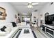 Open-concept living room with stylish decor, white sectional sofa, and views into the dining area at 6127 Sw 84Th Place Rd, Ocala, FL 34476