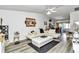 Bright living room with modern decor, a white sectional sofa, and elegant accents at 6127 Sw 84Th Place Rd, Ocala, FL 34476