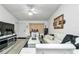 Cozy living room featuring a white sectional sofa and modern entertainment center at 6127 Sw 84Th Place Rd, Ocala, FL 34476