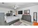 Comfortable main bedroom featuring modern decor, wood-look flooring, ensuite bathroom, and ample closet space at 6127 Sw 84Th Place Rd, Ocala, FL 34476