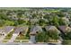 Aerial view of homes with well-kept lawns, beautiful trees, and paved driveways in a desirable location at 7432 Sw 98Th Ave, Ocala, FL 34481