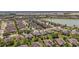 Scenic aerial view of a peaceful community with mature trees, a lake, and well-maintained green spaces at 7432 Sw 98Th Ave, Ocala, FL 34481
