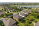 Stunning aerial shot of a residential area featuring verdant landscaping, a tranquil lake, and a community feel at 7432 Sw 98Th Ave, Ocala, FL 34481