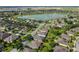 Aerial view of the community highlighting the lake, neighboring houses, and manicured lawns at 7432 Sw 98Th Ave, Ocala, FL 34481