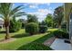Well-manicured backyard featuring lush green lawns and various trees at 7432 Sw 98Th Ave, Ocala, FL 34481