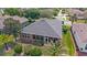 Aerial view of a well-maintained home featuring a screened lanai and a meticulously landscaped yard at 7432 Sw 98Th Ave, Ocala, FL 34481