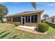 Home exterior featuring a screened-in lanai and manicured landscaping at 7432 Sw 98Th Ave, Ocala, FL 34481