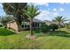 Well-maintained backyard with lush green lawn, tropical trees, and neat landscaping at 7432 Sw 98Th Ave, Ocala, FL 34481