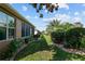 Beautiful backyard with well-manicured lawn, mature trees, and brick-lined flower beds at 7432 Sw 98Th Ave, Ocala, FL 34481