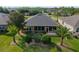 Aerial view highlights landscaped backyard with lush lawn, decorative stone borders, and a screened in porch at 7432 Sw 98Th Ave, Ocala, FL 34481
